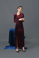 Velvet long-sleeve evening gown with draped neckline and high slit in floor-length silhouette